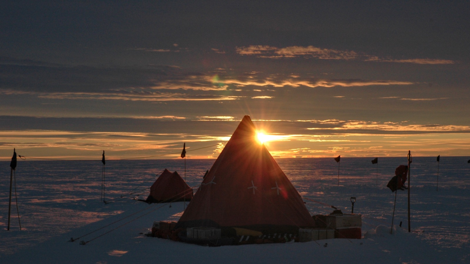 Sunset over a tent in the arctic.