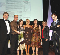 Steve Riches, left, presenting big chip award to iKnow-UK. with host Anthony Wilson on the right