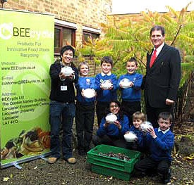 Kenneth Cheung with headteacher Len Guest (right) and pupils at Moorside Primary School