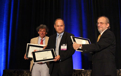 Peter Erdi, Plamen Angelov, and Daniel Levine receiving their awards for outstanding service at the IJCNN 2013. Photo by Wentao Guo.