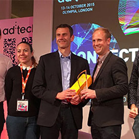 Relative Insight's CEO Ben Hookway (centre) receiving the award.