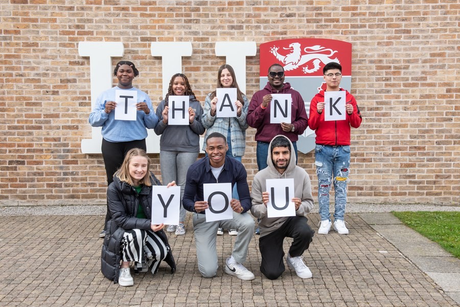 Student call team holding thank you signs