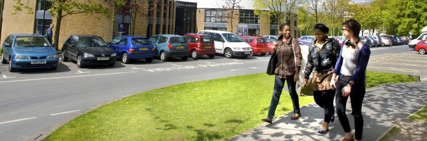 Three females walking in campus car park