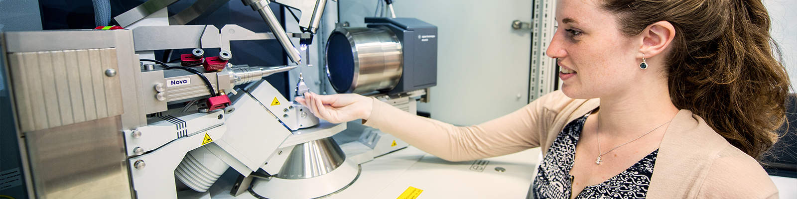 A woman sits using an X-Ray Diffractor in the Chemistry Department