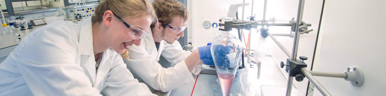 Two students preparing samples
