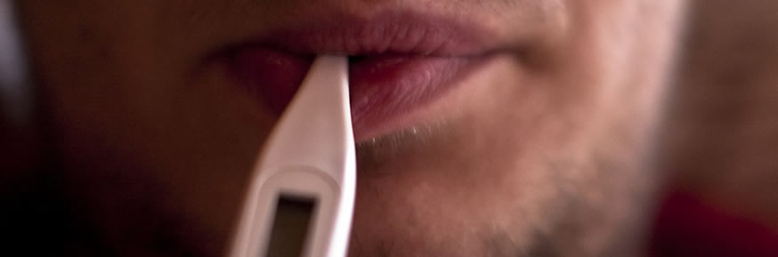 Man with a thermometer in his mouth