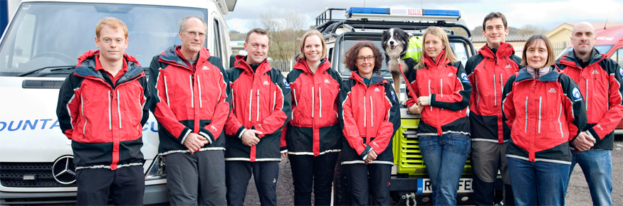 Photograph of nine of the twelve Lancaster University alumni, who are also members of the Bowland Pennine Mountain Rescue Team.