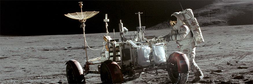 The Apollo 15 Lunar Rover on the surface of the Moon with astronaut Jim Irwin alongside. Tracks in the dusty lunar soil are clearly visible. Credit: NASA