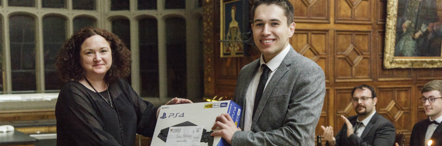 Michelle Houghton from the Inter-Ace cyber security challenge presents Lancaster's Jonas Pertschy with his prize