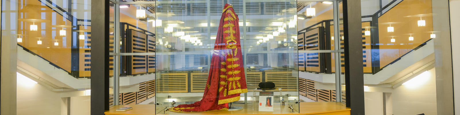 Lancaster University Chancellor's robes in glass cabinet within the Library building