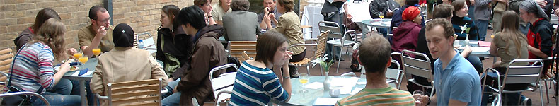 Students seated in groups at our postgraduate induction event