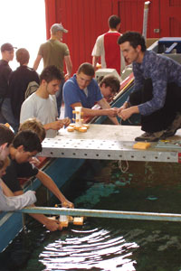 Students gather round Engineering's wave tank to test their designs