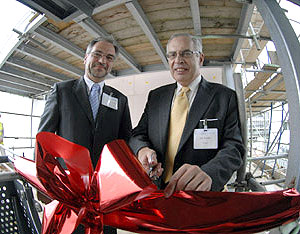 Professor Trevor McMillan, Lancaster University's Pro-ViceChancellor for research and Joe Dwek CBE, Board member of the NWDA, cutting a ribbon to mark the linking of the new building with the existing LEC building