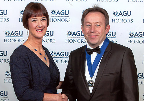 Professor Binley receiving his award from AGU president Carol Finn