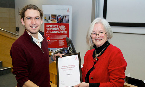 Poster competition winner Samuel harrison receives his award from Dean of Science and Technology Professor Mary Smyth