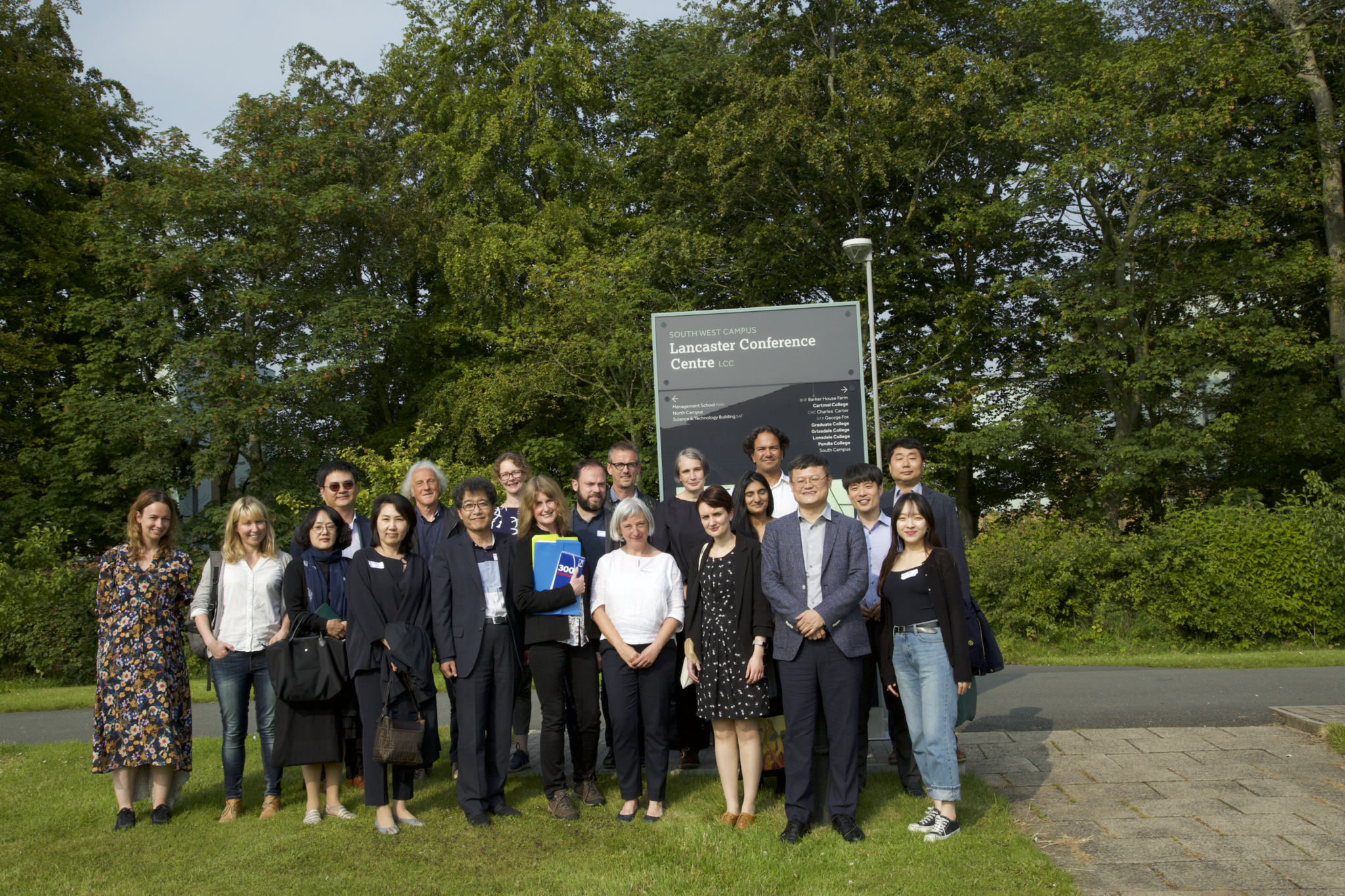 group of people stood in front of a sign that reads 'Lancaster Conference Centre'