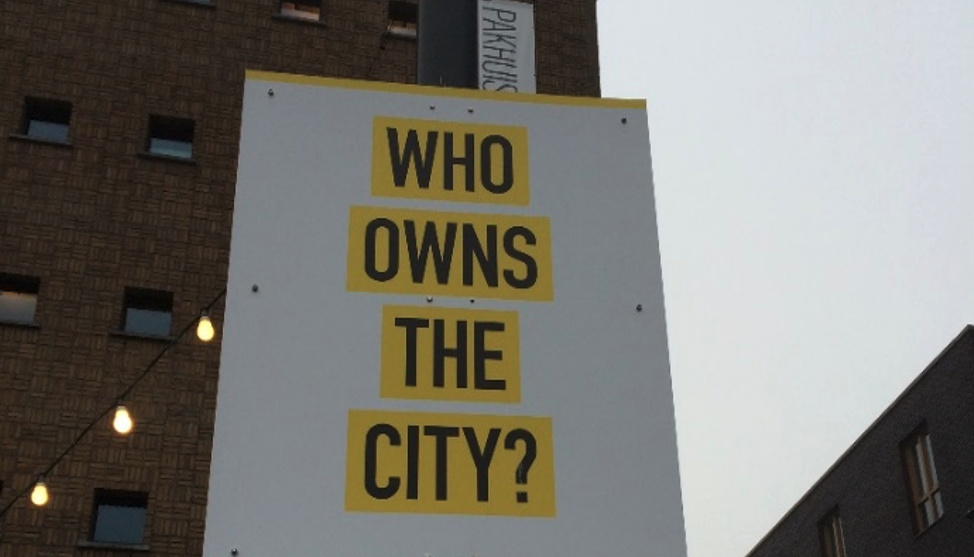 Who owns the city Image of a sign saying 'Who owns the City?'