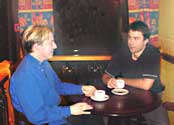 two men in a cafe drinking coffe