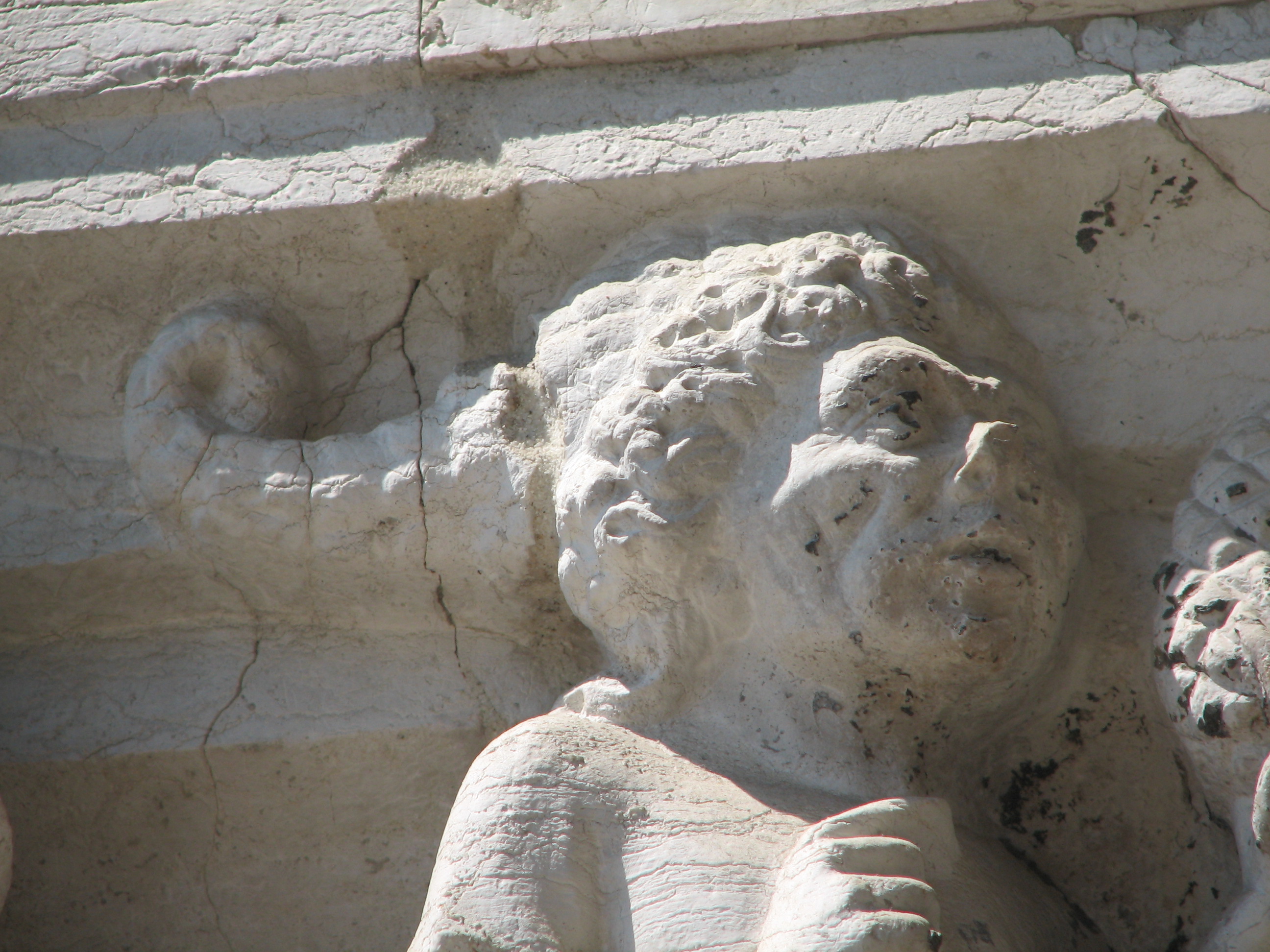 Lower Capitals of the Ducal Palace. Detail of 8th Capital Head of face hollow cheeked