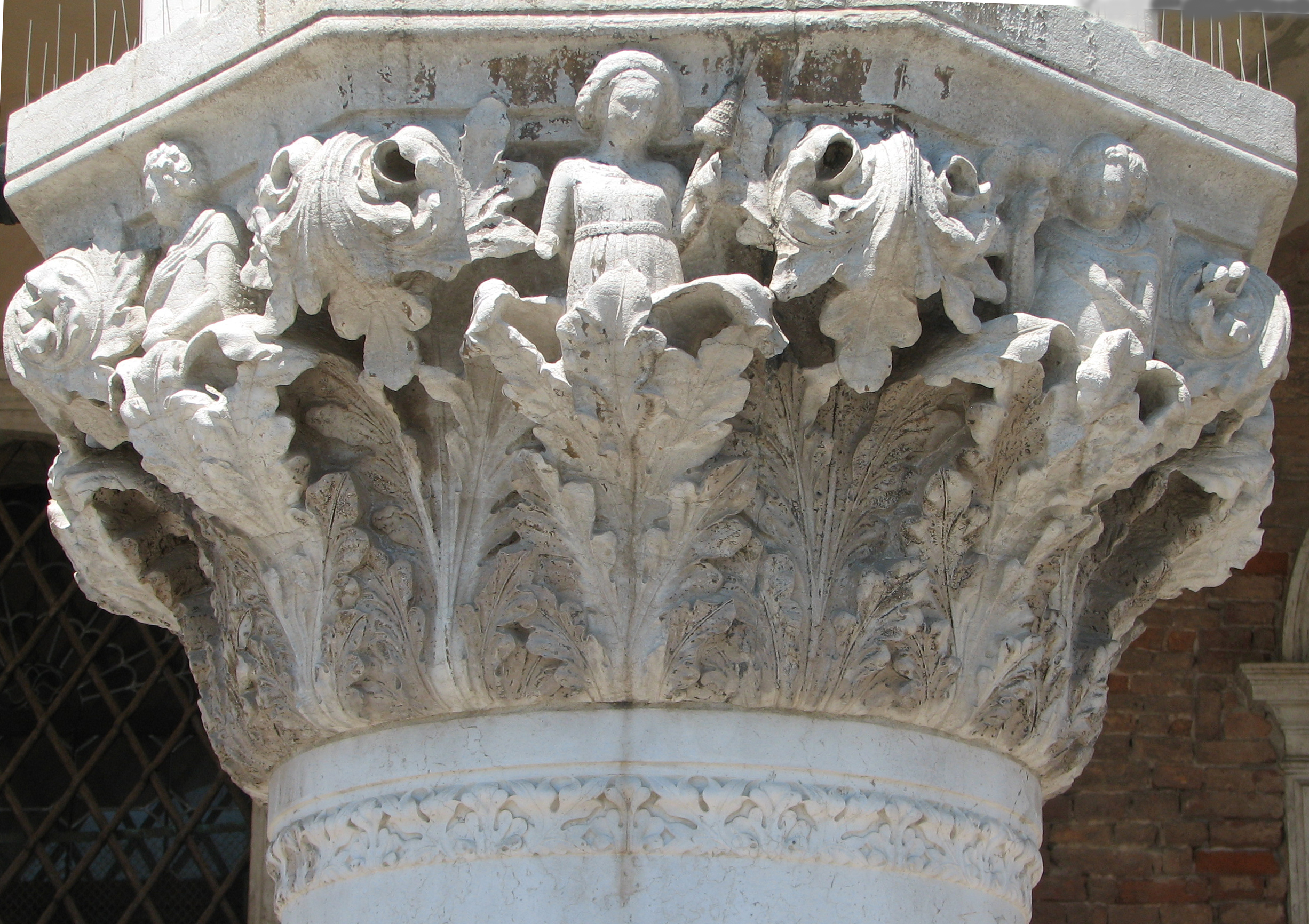 Detail of 15th capital in its current state Boy with ball, side 8, left; Woman with distaff, side 1, centre; Youth with long mantle, side 2, right