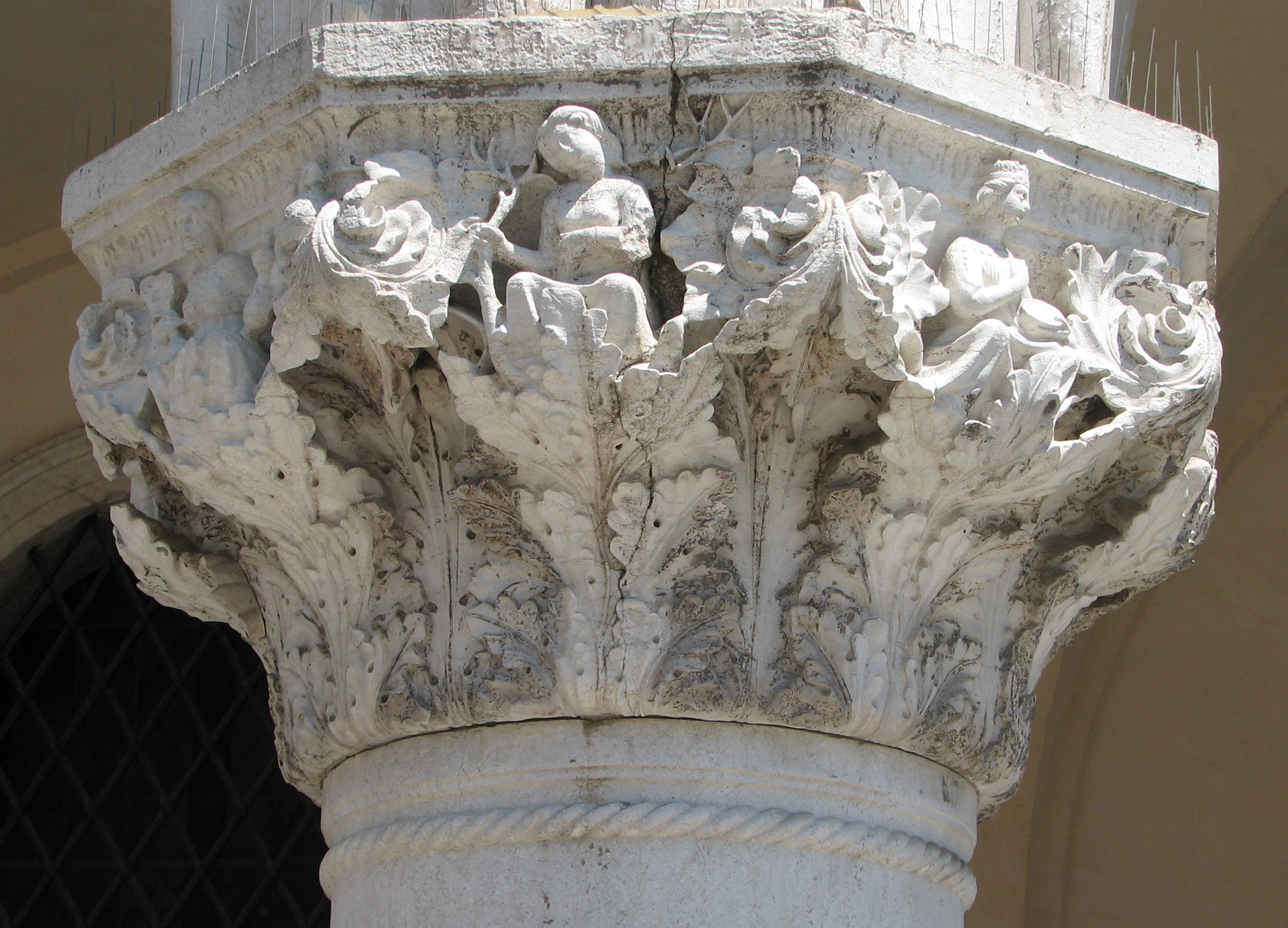 Detail of 30th capital in its current state Envy, side 8, left; Luxury, side 1, centre, Gluttony, side 2, right