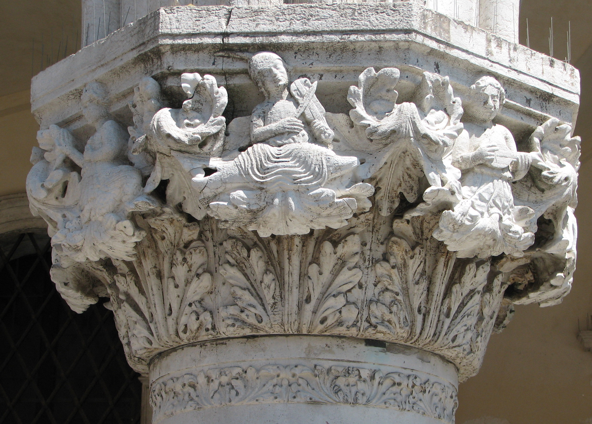 Detail of 31st capital in its current state Figure with curly hair side 8 left, Arion side 1 centre, Human figure with legs of a bear side 2 right