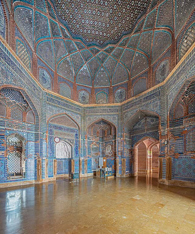  The inside of the Shah Jahan Mosque with a domed ceiling covered in ornate blue tiles and geometric Islamic art.