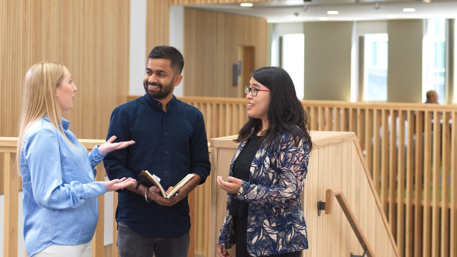 Students and staff chat in the Management School.