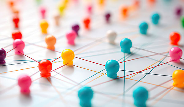 Close up view of threads connected by a thumbtack