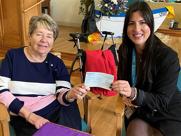 Defying Dementia supporter with cheque