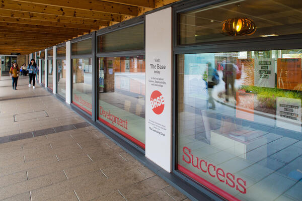 Student services building, with notices and signage on the windows.