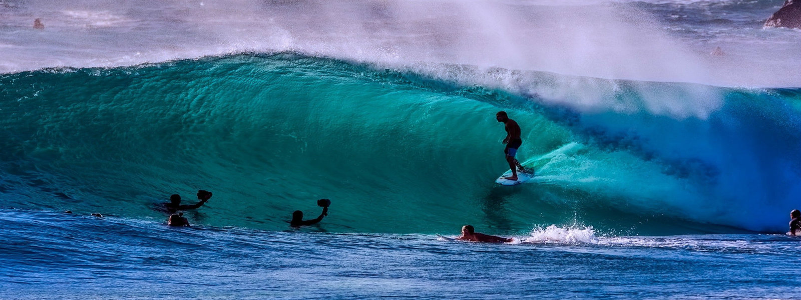 Person surfing within a large wave