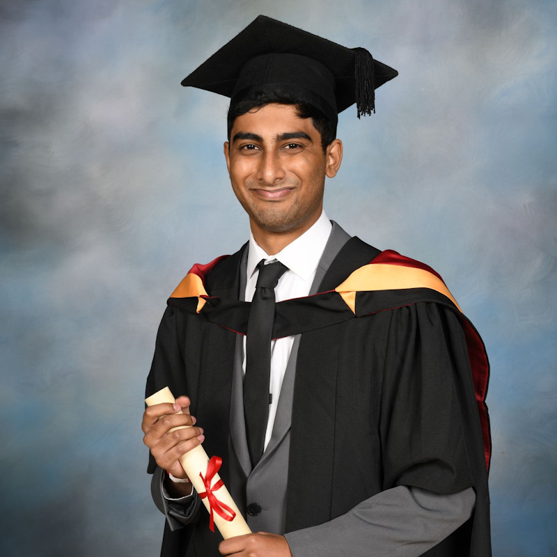 Image of Biomedical Science graduate Santosh, wearing graduation cap and gown
