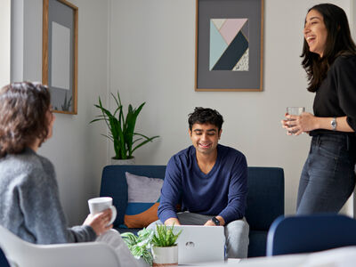 Three students socialising in on-campus accommodation