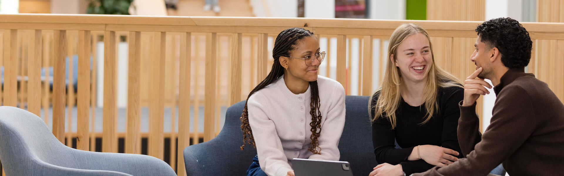 Students on laptops in postgraduate study space