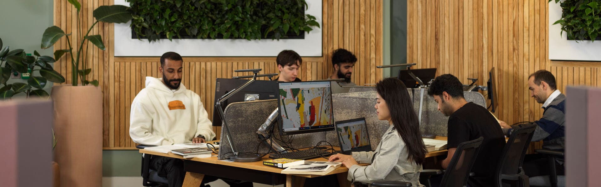 Students on laptops in postgraduate study space