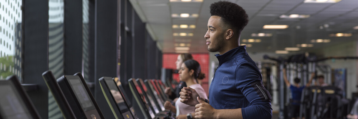 student running in the gym on a treadmill 