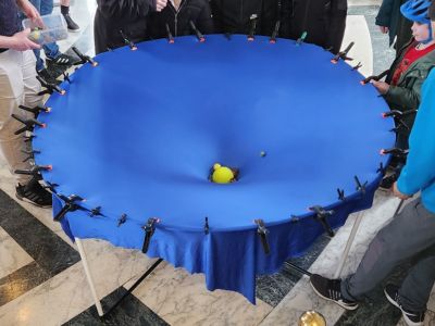 big marbles sit in the centre of a large blue cloth
