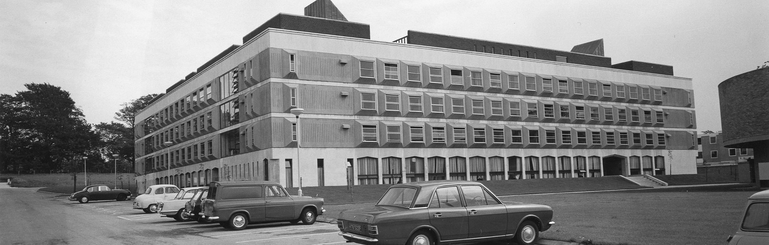 old photo of County main from 1970s with old cars in foreground