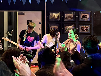 Students watching a performance by the band Paragon