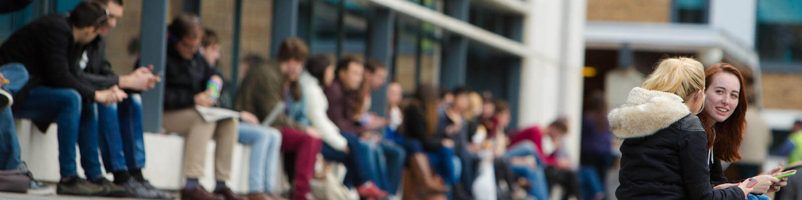 Students sitting outside on some steps