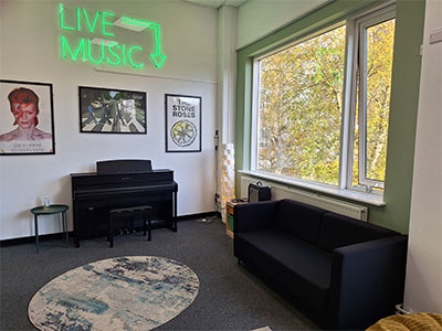 Pendle college music room with piano and neon sign 