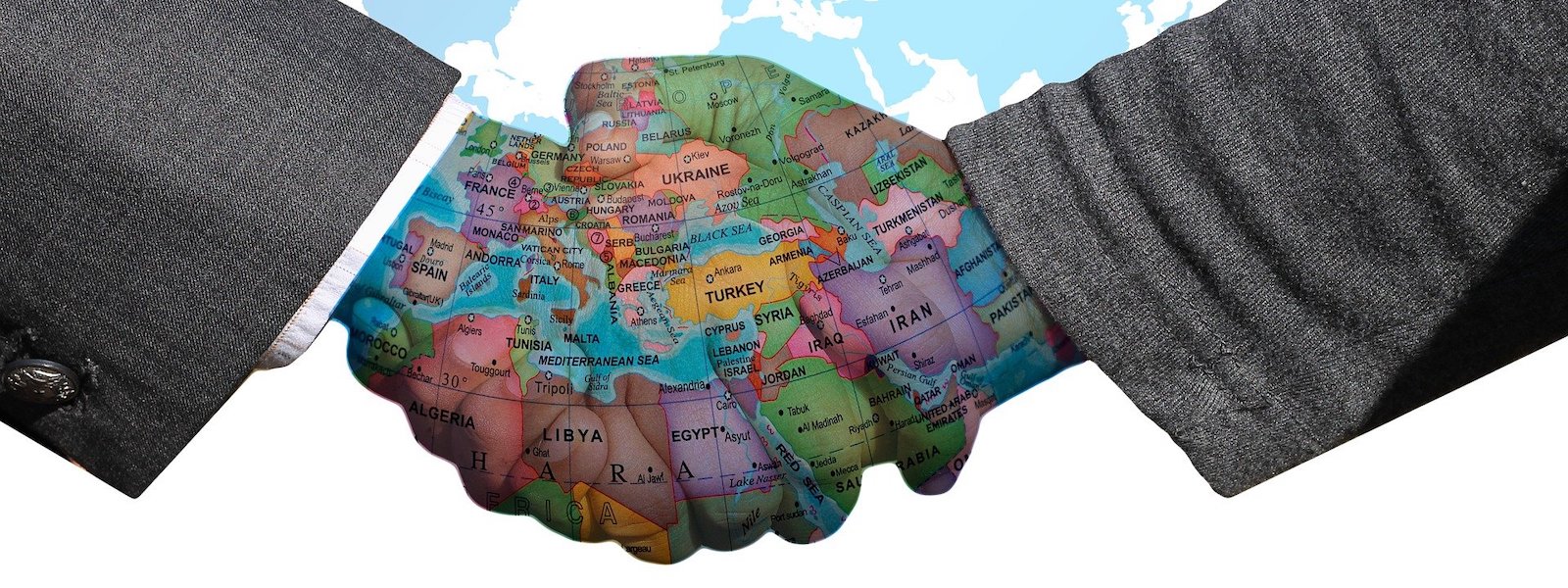 Handshake imposed over world map, imposed over blue sky. Image by Gerd Altmanm from Pixabay. 