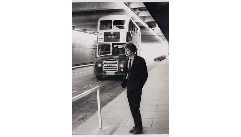 Black and white photo of the university underpass with an old style bus