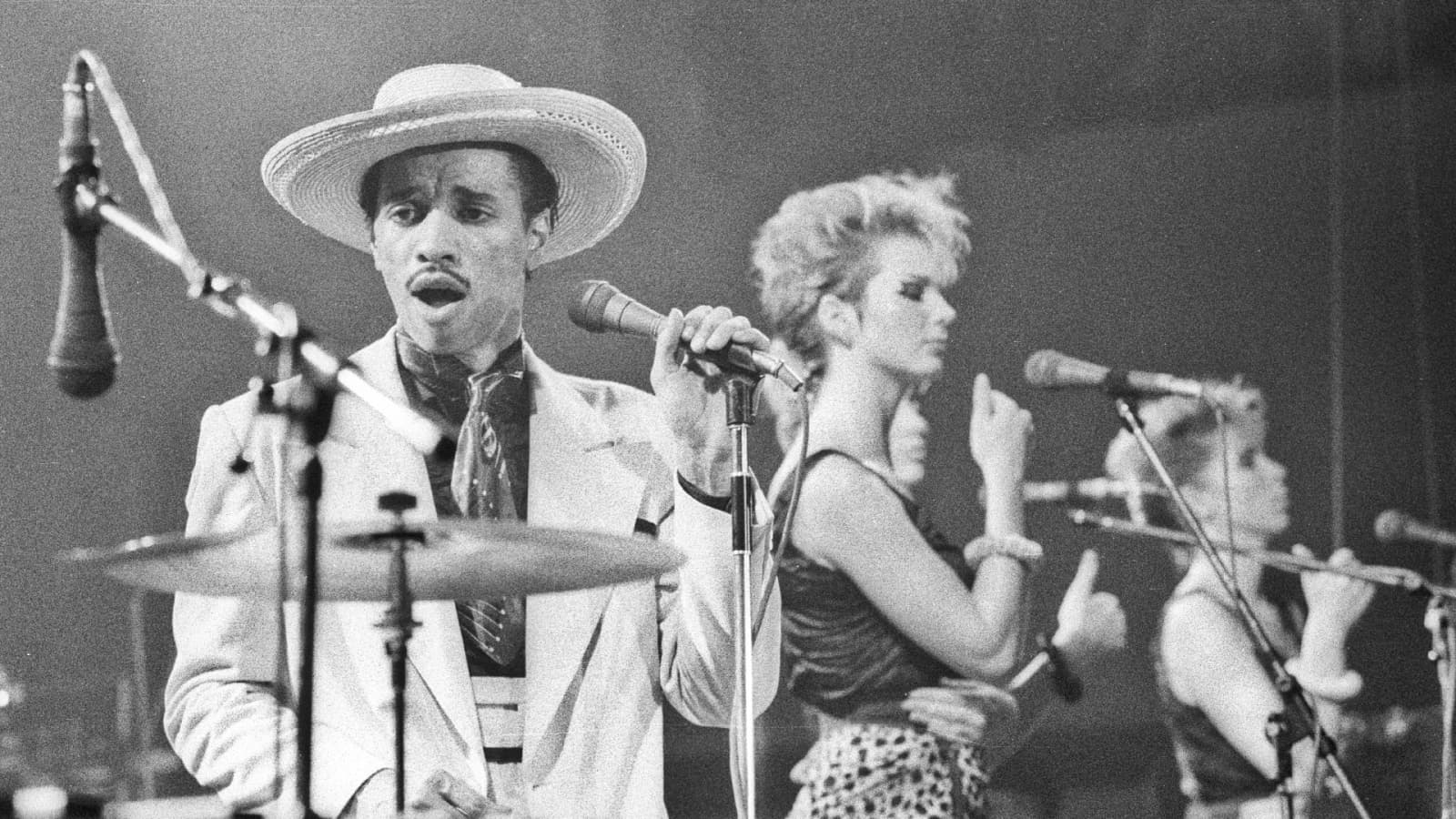 Kid Creole and two backing singers on stage in Lancaster