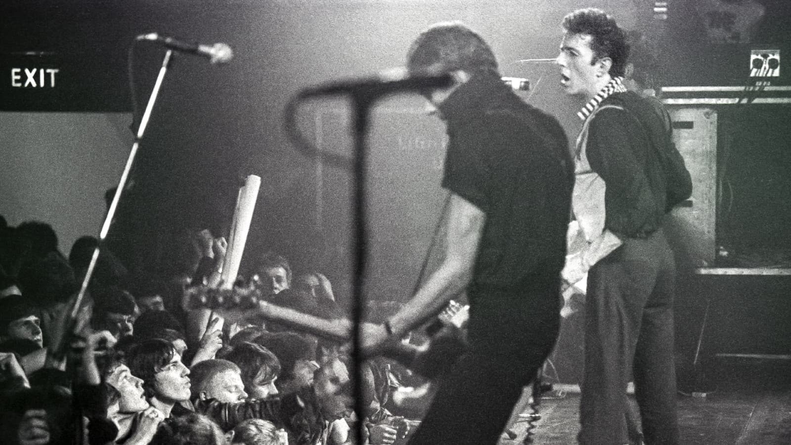 Joe Strummer from The Clash stands in front of a rapt audience