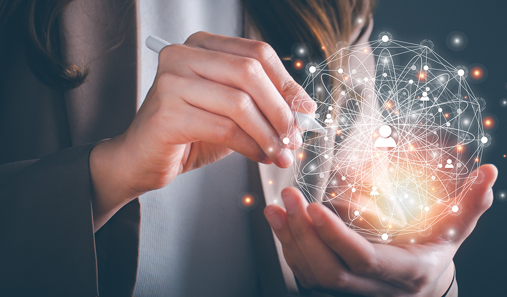 Image shows hands holding CGI technology ball