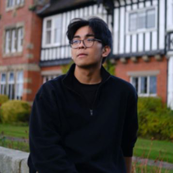 Image of Agastya looking into the distance, stood in front of the School of Architecture building