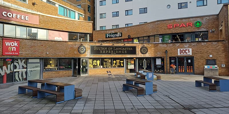 Shops and seating areas at Edward Roberts Court, Lancaster University.