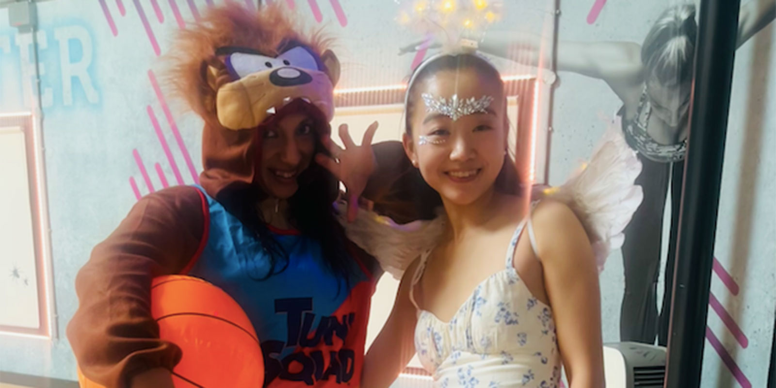 Two people smiling and posing for a picture at the BodyJam fitness class. 